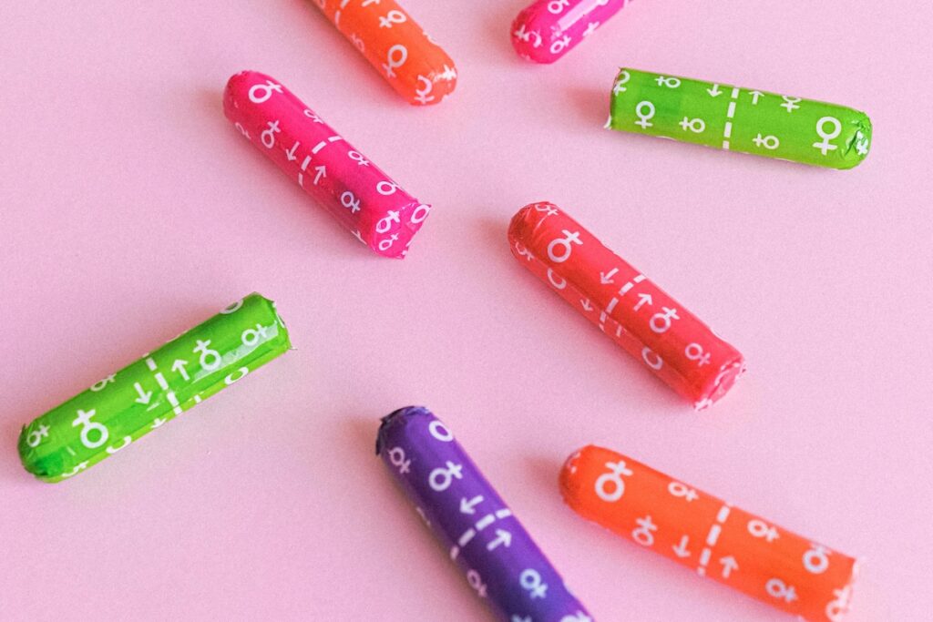 Various tampons on a pink background