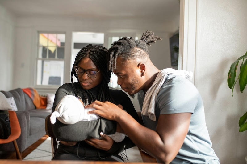 Couple holding newborn baby