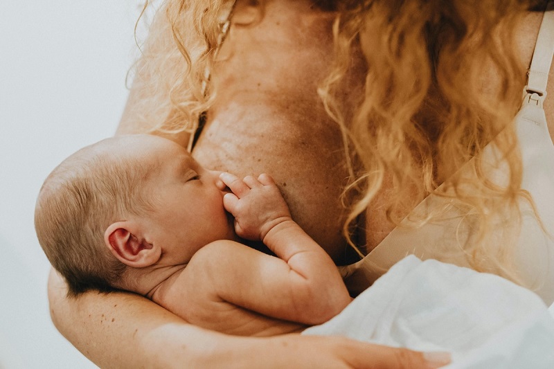 A parent breastfeeding a child