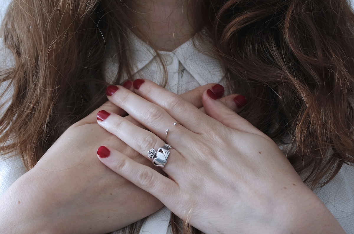 person crossing hand and placing on the chest