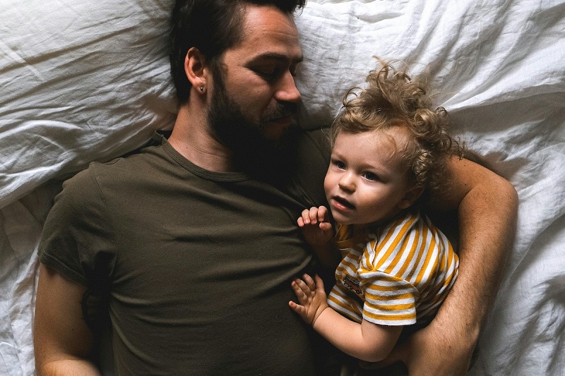 parent and a baby sleeping together