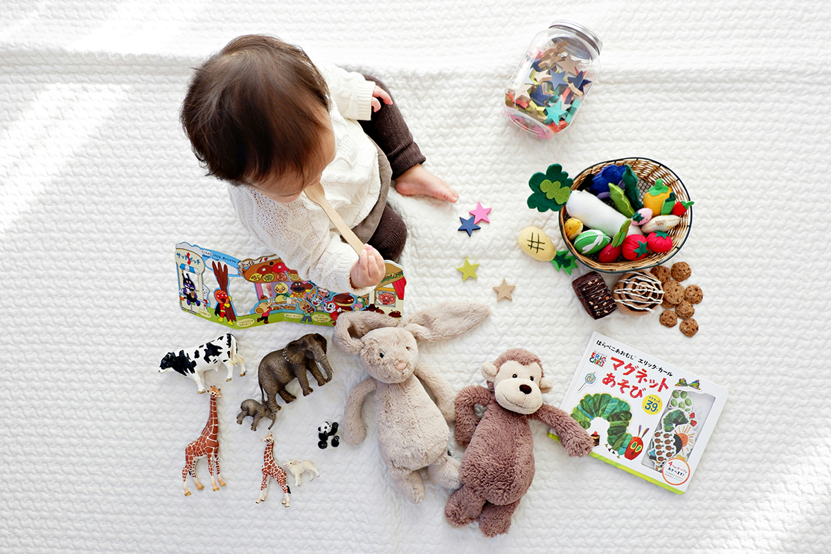 baby sitting with toys around