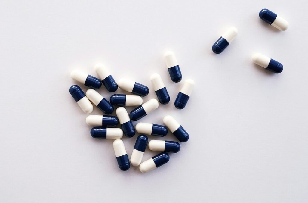 black and white capsules on a grey background