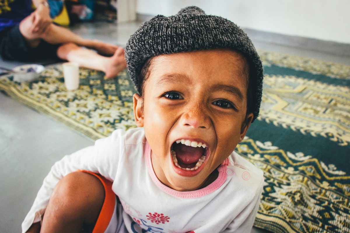 Kid showing his tongue with full open mouth