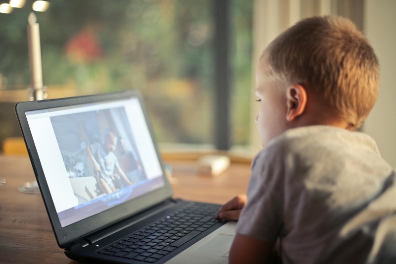 kid watching video on a laptop