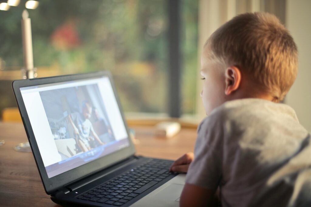 kid watching video on a laptop