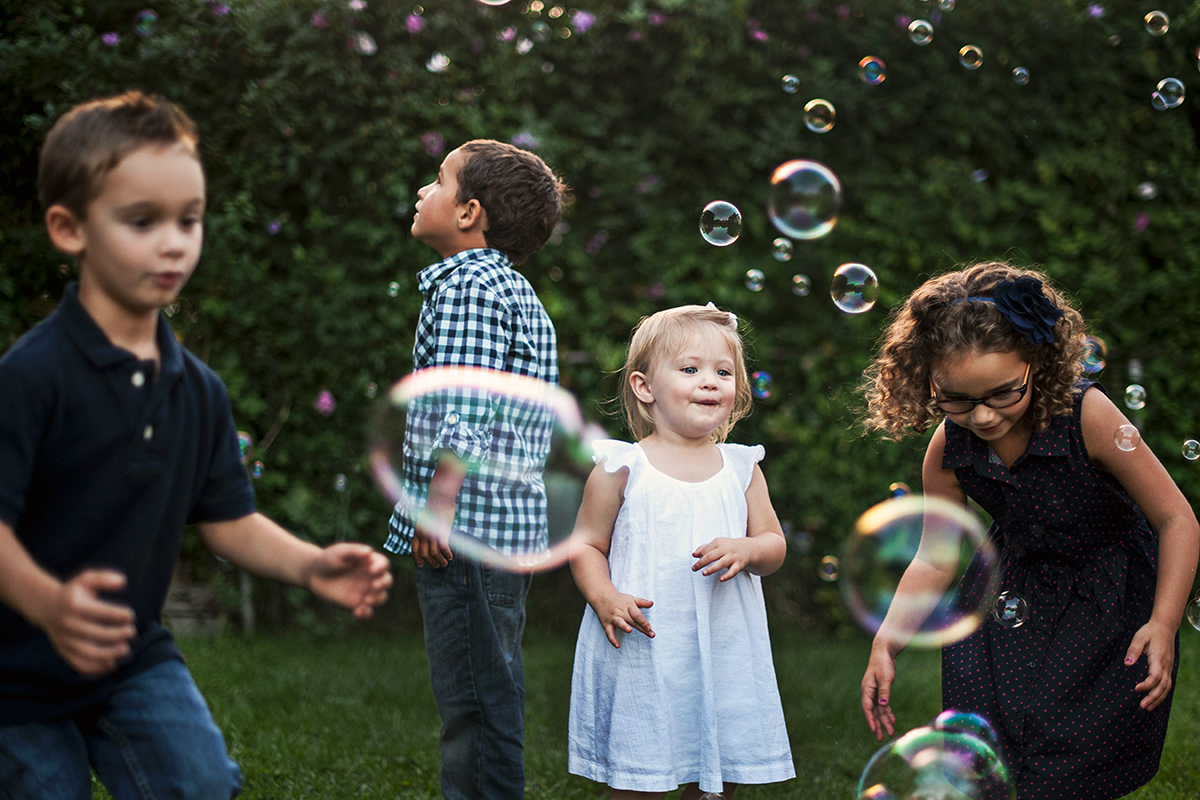 little boys and girls playing in the garden