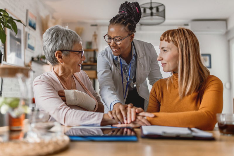 two person sitting and talking with doctor