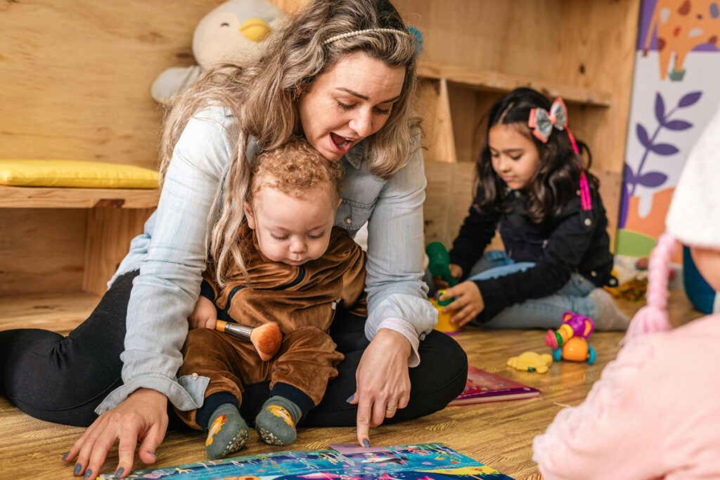 an adult playing with kids on the floor