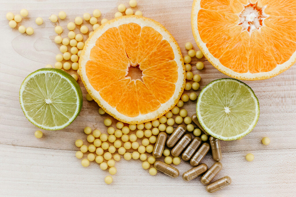 fruits and capsules placed on a table