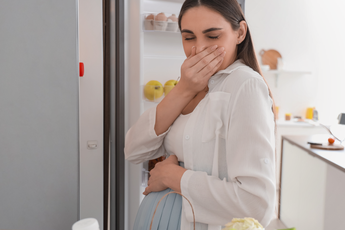 an adult holding standing and holding nose because of smell