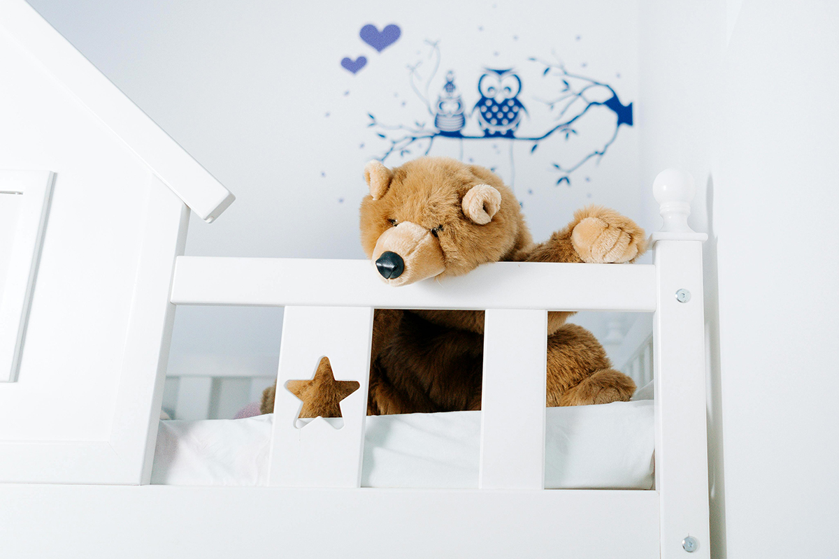 A teddy bear in a crib