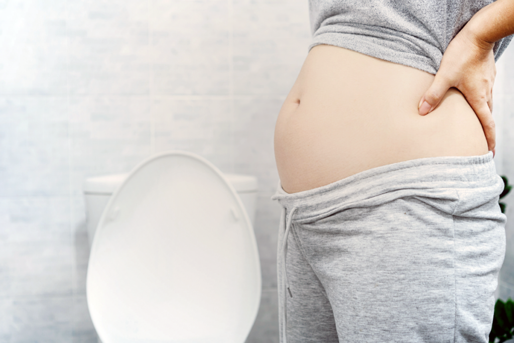 a pregnant person standing in bathroom