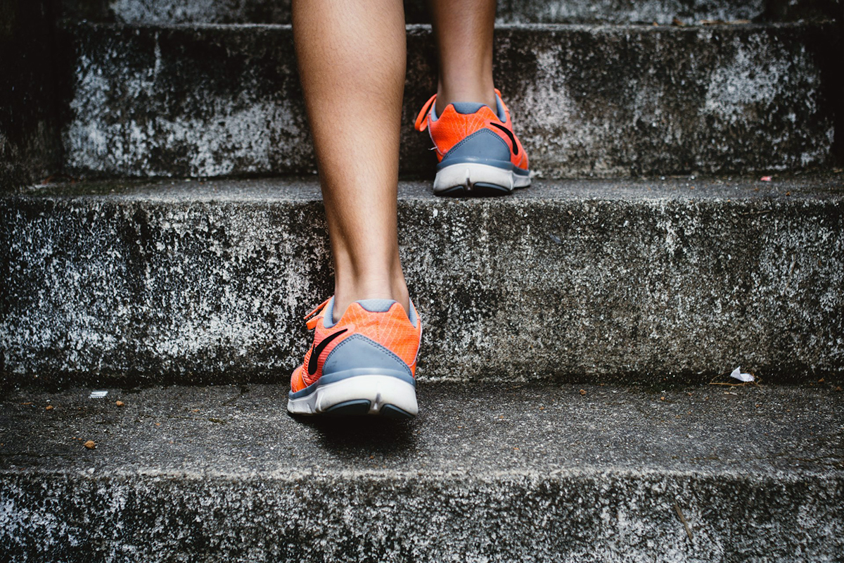 close up of legs of an adult going up using staircase