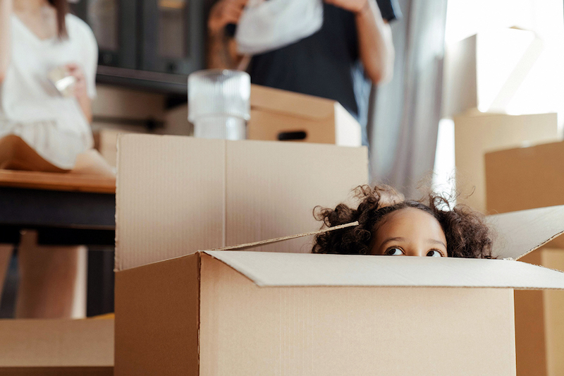 A kid hiding in a box