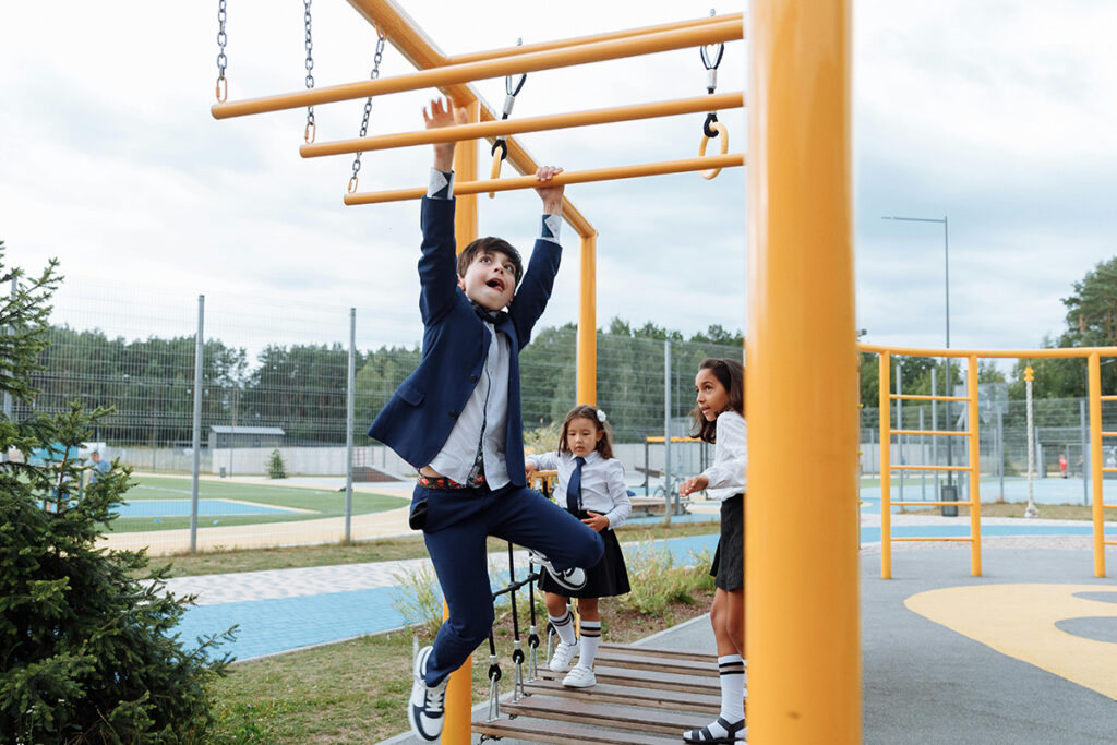 A kid playing in the monkey ladder