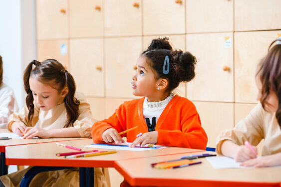 Three kids doing work in a school