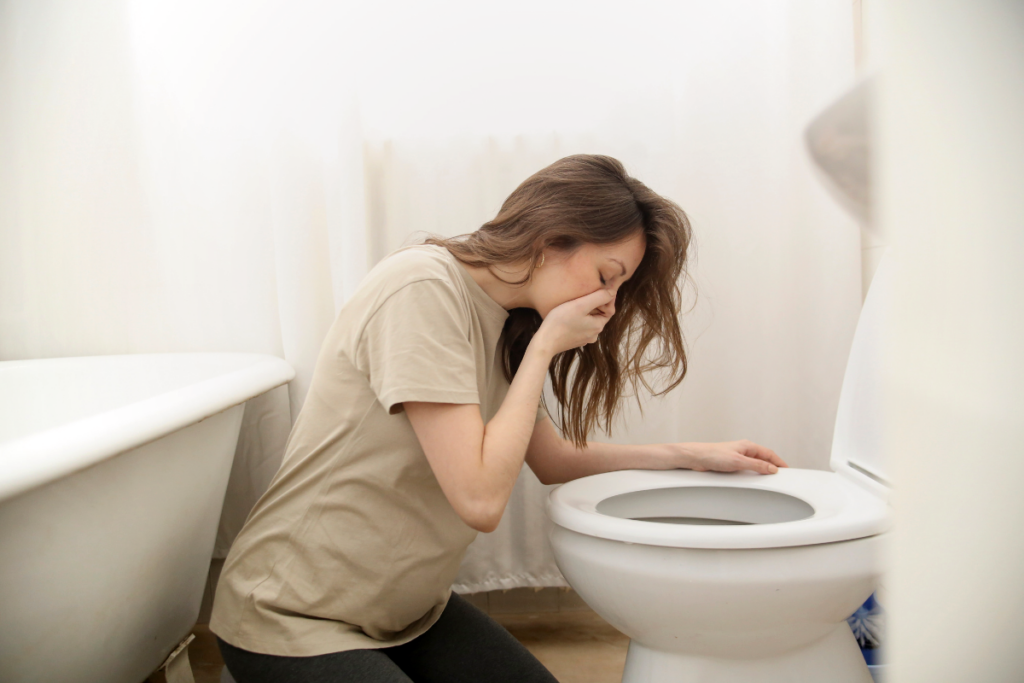 A person vomiting in a bidet