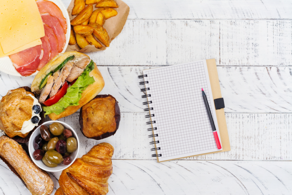 Junk food on the side with a notebook and a pen.