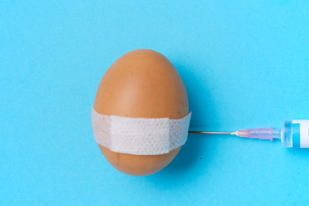 An egg with a bandaid being injected