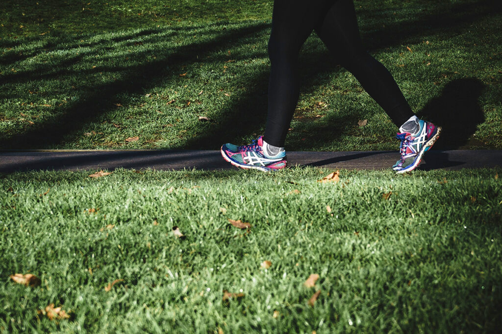 Zoom in of a person's legs walking on shoes