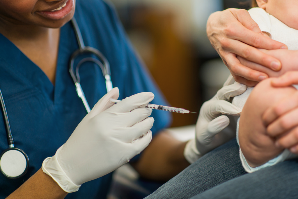 Pediatrician giving a baby a vaccination.