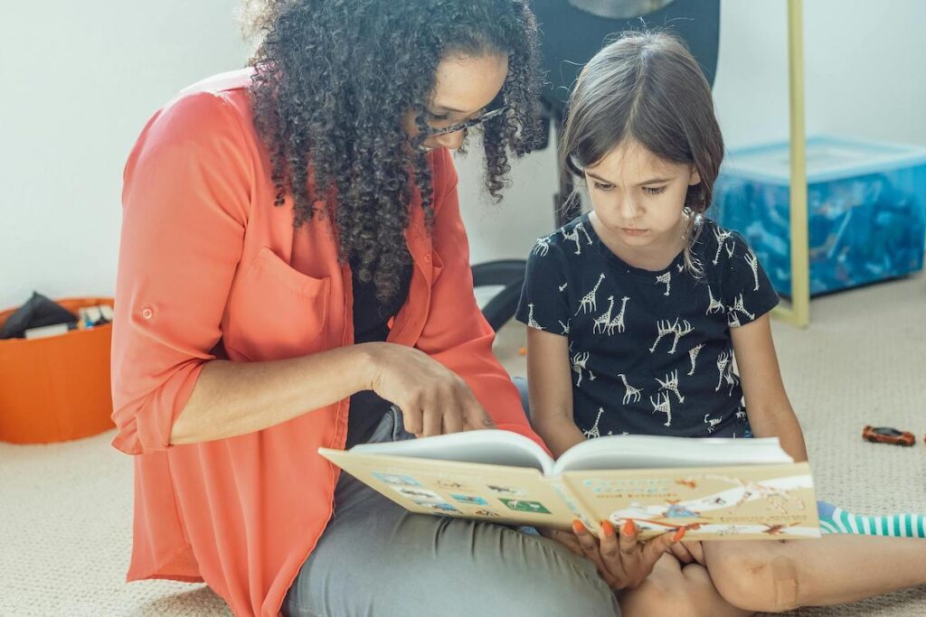 A parent teaching a kid to read.