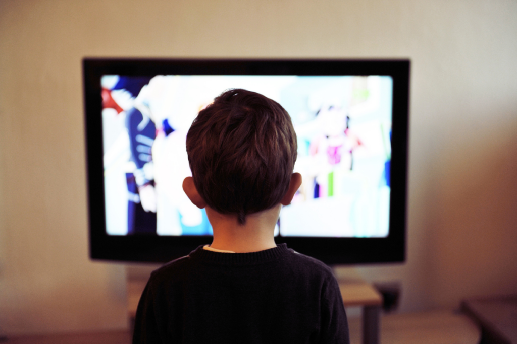 A kid watching tv.