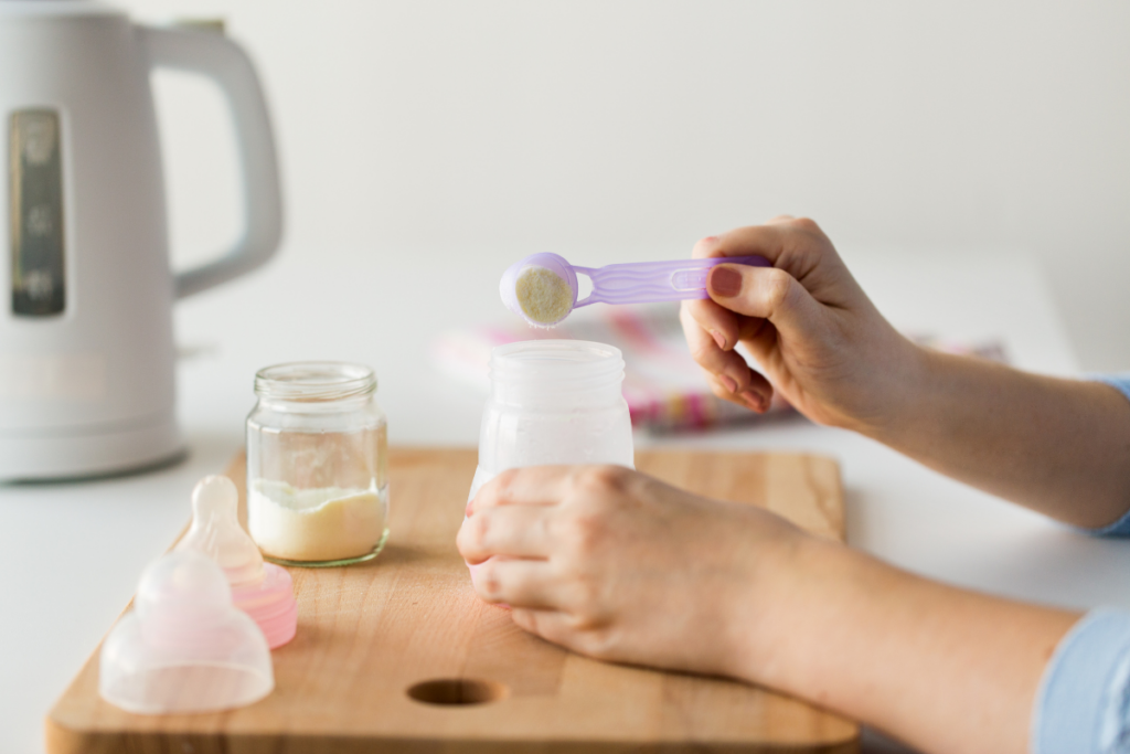 A person mixing formula in a bottle