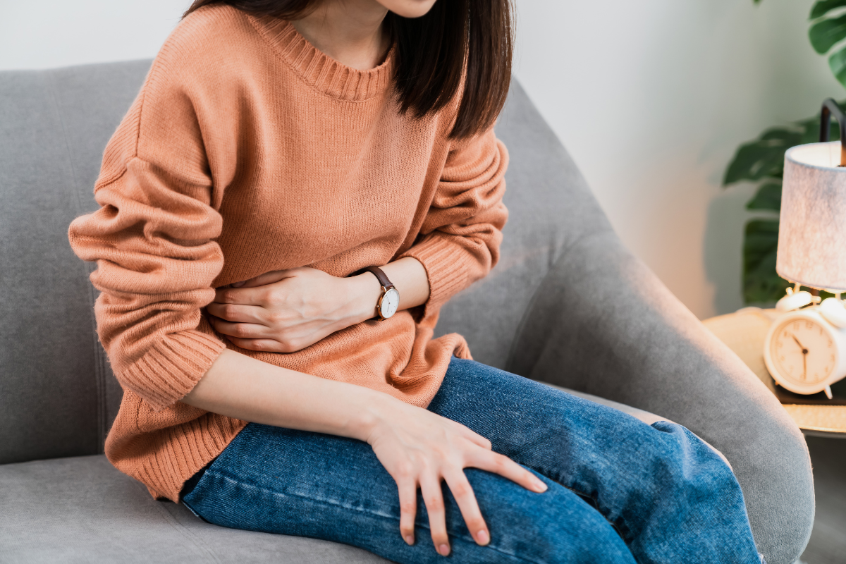 A person holding her stomach.