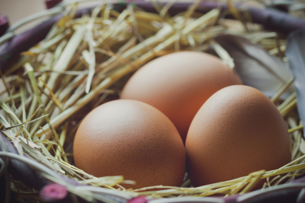 Three eggs in a basket.