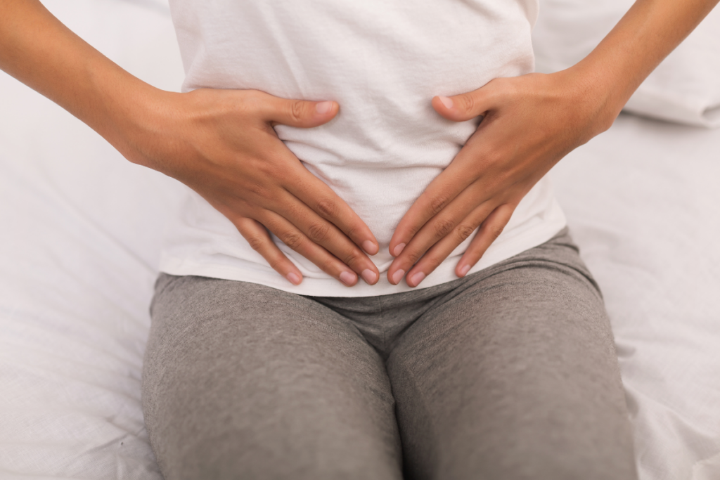 A person holding her stomach in pain