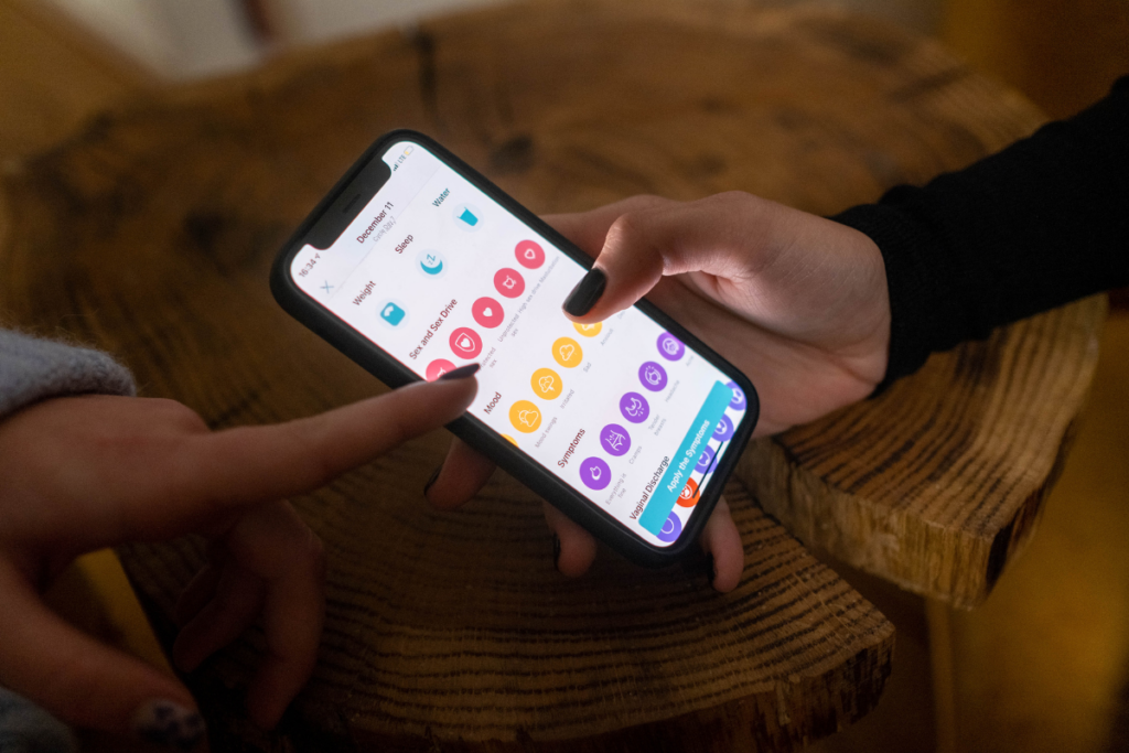 A person checking a fertility tracking app.