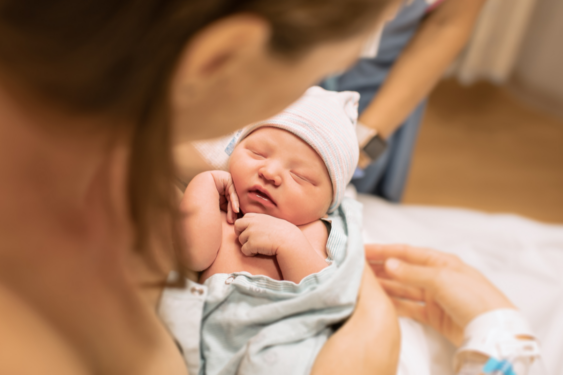 A parent holding a newborn.