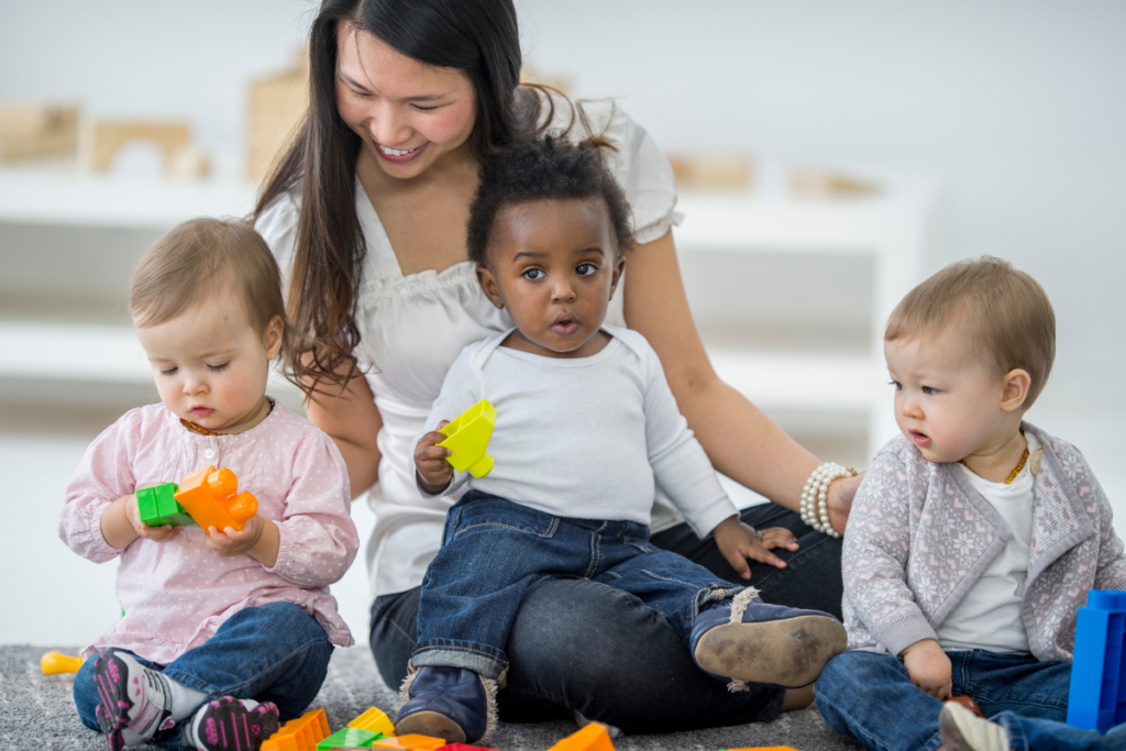 A care taker with children in a daycare.