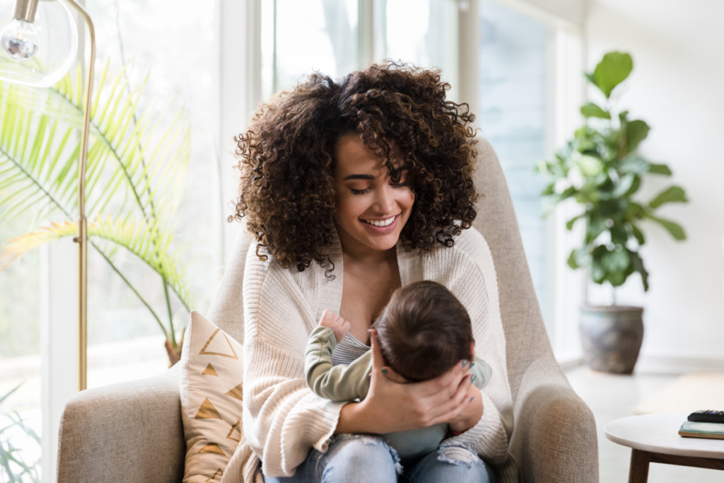 A parent playing with a newborn.