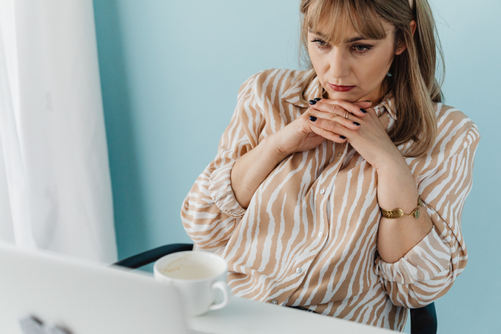 A woman staring at a laptop.