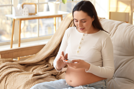 A pregnant person checking sugar levels.