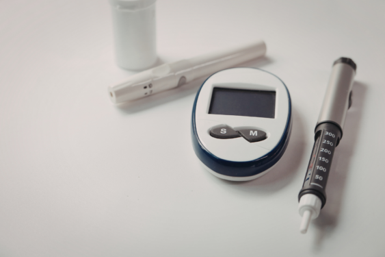 A glucose monitor and a glp 1 syringe.